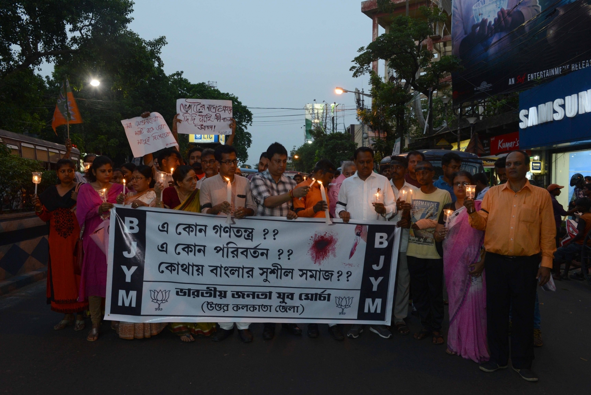 Kolkata: BJP Yuva Morcha activists participate in a candle light rally organised to protest against violence during West Bengal Panchayat Polls in Kolkata, on May 15, 2018. (Photo: IANS)