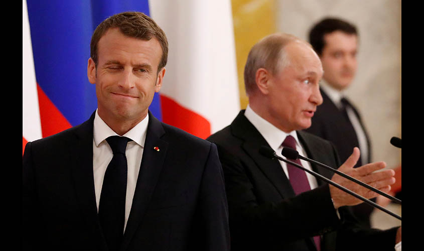 Russian President Putin and his French counterpart Macron attend a news briefing in St. Petersburg