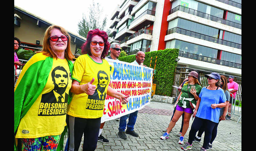 Supporters of Brazil's president-elect Jair Bolsonaro wait outside Bolsonaro's condominium at Barra da Tijuca neighbourhood in Rio de Janeiro
