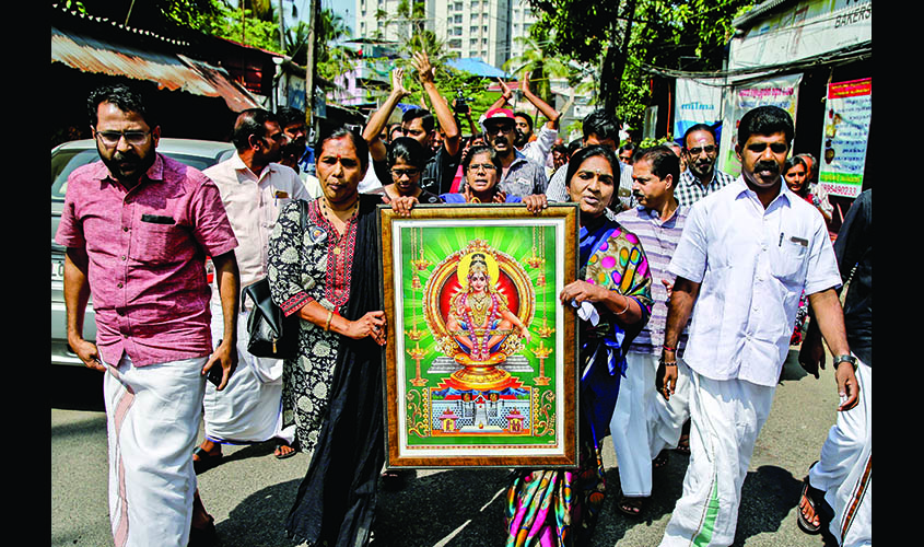Protesters hold a portrait of Hindu deity ìAyappaî as they take part in a rally called by various Hindu organisations after two women entered the Sabarimala temple, in Kochi