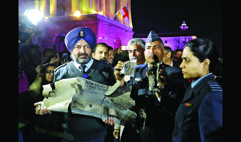 Indian Air Force officials display a wreckage of AMRAAM air-to-air missile that they say was fired by Pakistan Air Force fighter jet during a strike over Kashmir on Wednesday, after speaking with media in lawns of India's Defence Ministry in New Delhi