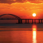 A general view shows a road-and-rail bridge, which is constructed to connect the Russian mainland with the Crimean peninsula, during sunrise in the Kerch Strait, Crimea, on 3 April. REUTERS