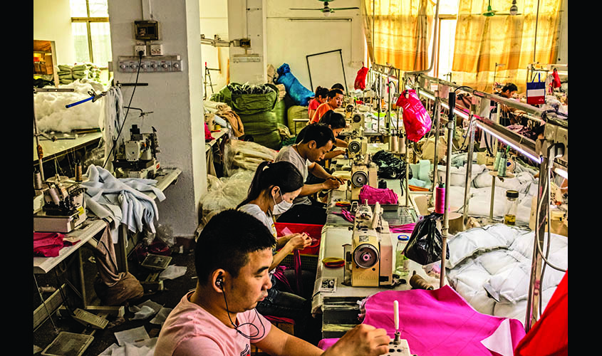 Garment factory workers work inside a factory in Guangzhou, China.