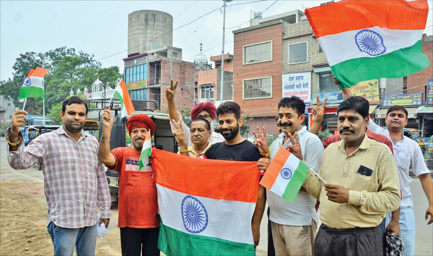People celebrate the Centre’s decision to scrap Article 370 of the Constitution and to give Jammu and Kashmir a Union Territory status; in Amritsar, on Monday. IANS