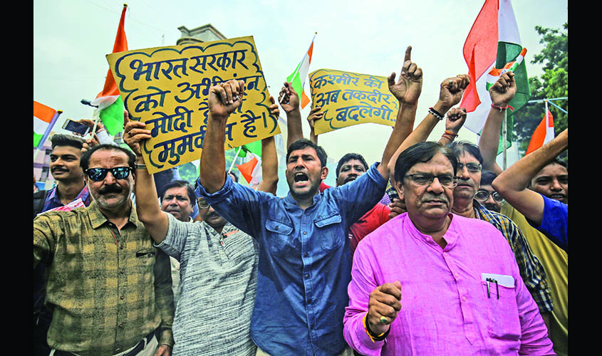People shout slogans as they celebrate after the government scrapped the special status of Kashmir, in Ahmedabad