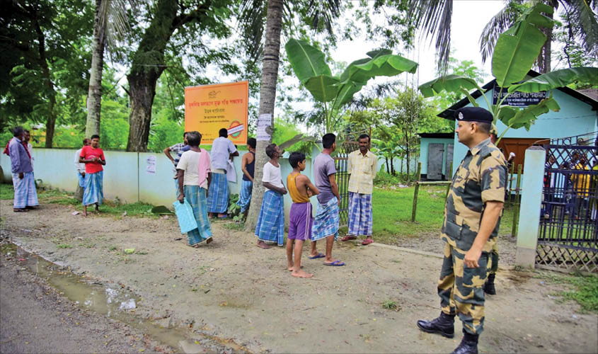 People wait outside an NRC Seva Kendra to check their names in the final list of the National Register of Citizens (NRC), in Assam’s Nagaon on 31 August. IANS