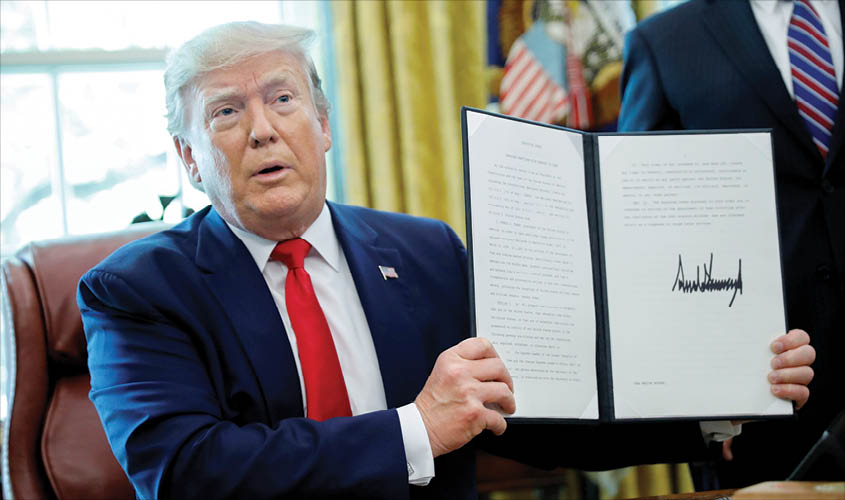 US President Donald Trump displays an executive order imposing fresh sanctions on Iran in the Oval Office of the White House in Washington, US, on 24 June. REUTERS
