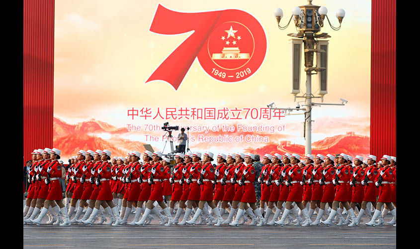 Militia members march in formation past Tiananmen Square during a rehearsal before a military parade marking the 70th founding anniversary of People's Republic of China