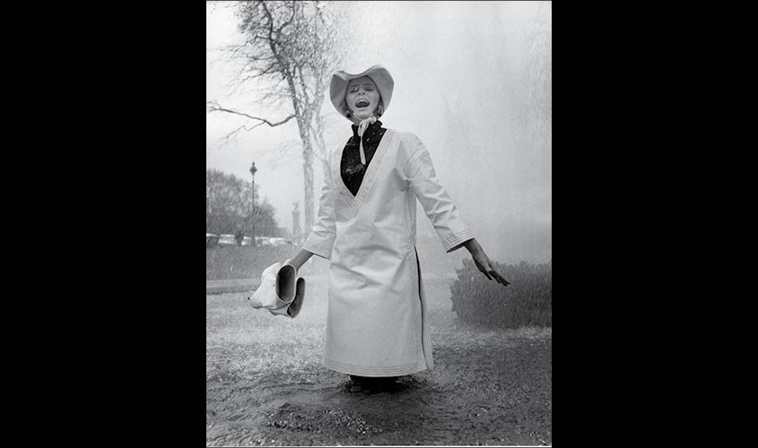 Jill Kennington wearing white PVC rain tunic and hat. Photograph by John Cowan, 1963. © Ernestine Carter Archive, Fashion Museum Bath.