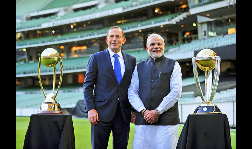 India's Prime Minister Modi and Australian Prime Minister Abbott pose with the cricket World Cup trophies during a reception at the Melbourne Cricket Ground