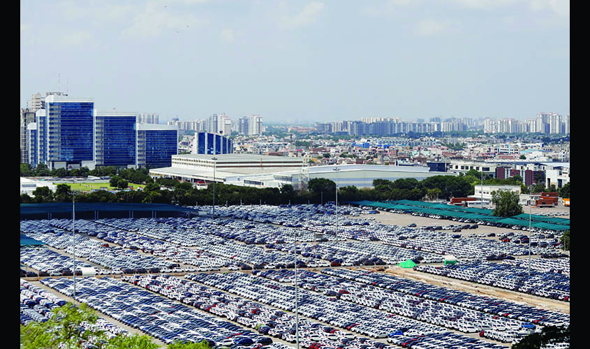 Cars are seen parked at Maruti Suzuki's plant at Manesar