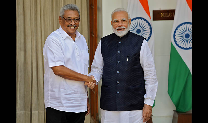 Sri Lanka's President Rajapaksa and India's PM Modi shake their hands during a photo opportunity ahead of their meeting at Hyderabad House in New Delhi