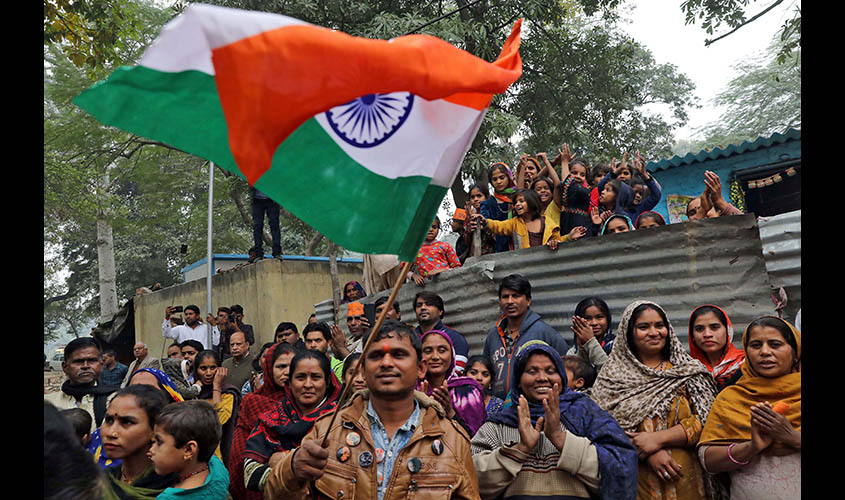 People, who claim to have migrated from Pakistan's Sindh Province, cheer as they celebrate after India's parliament passed a Citizenship Amendment Bill, at Majnu Ka Tila in New Delhi
