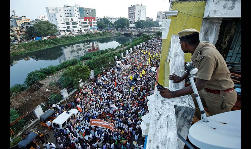 A policeman looks on as supporters of India's ruling Bharatiya Janata Party (BJP) attend a rally in support of a new citizenship law, in Chennai