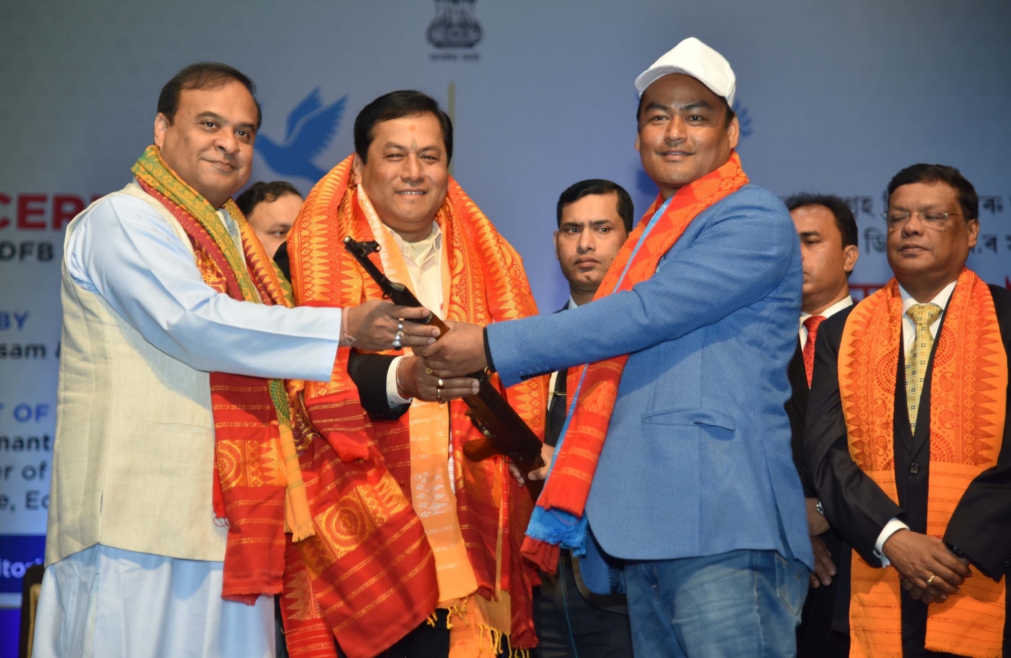 Guwahati: National Democratic Front of Bodoland (NDFB) leader B Saoraigra surrenders his arms before Assam Chief Minister Sarbananda Sonowal and Finance Minister Himanta Biswa Sarma during a programme where over 1,500 members of all four factions of the separatist NDFB laid down arms, in Guwahati on Jan 30, 2020. (Photo: IANS)