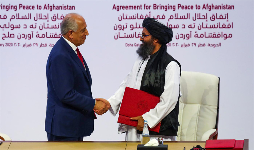 File photo of the deal signed in Doha between US special envoy Zalmay Khalilzad and Taliban political chief Mullah Abdul Ghani Baradar on 29 February.