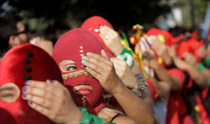 Women wearing masks take part in a protest against gender violence and the Chile’s government in Santiago, Chile December 6, 2019. REUTERS