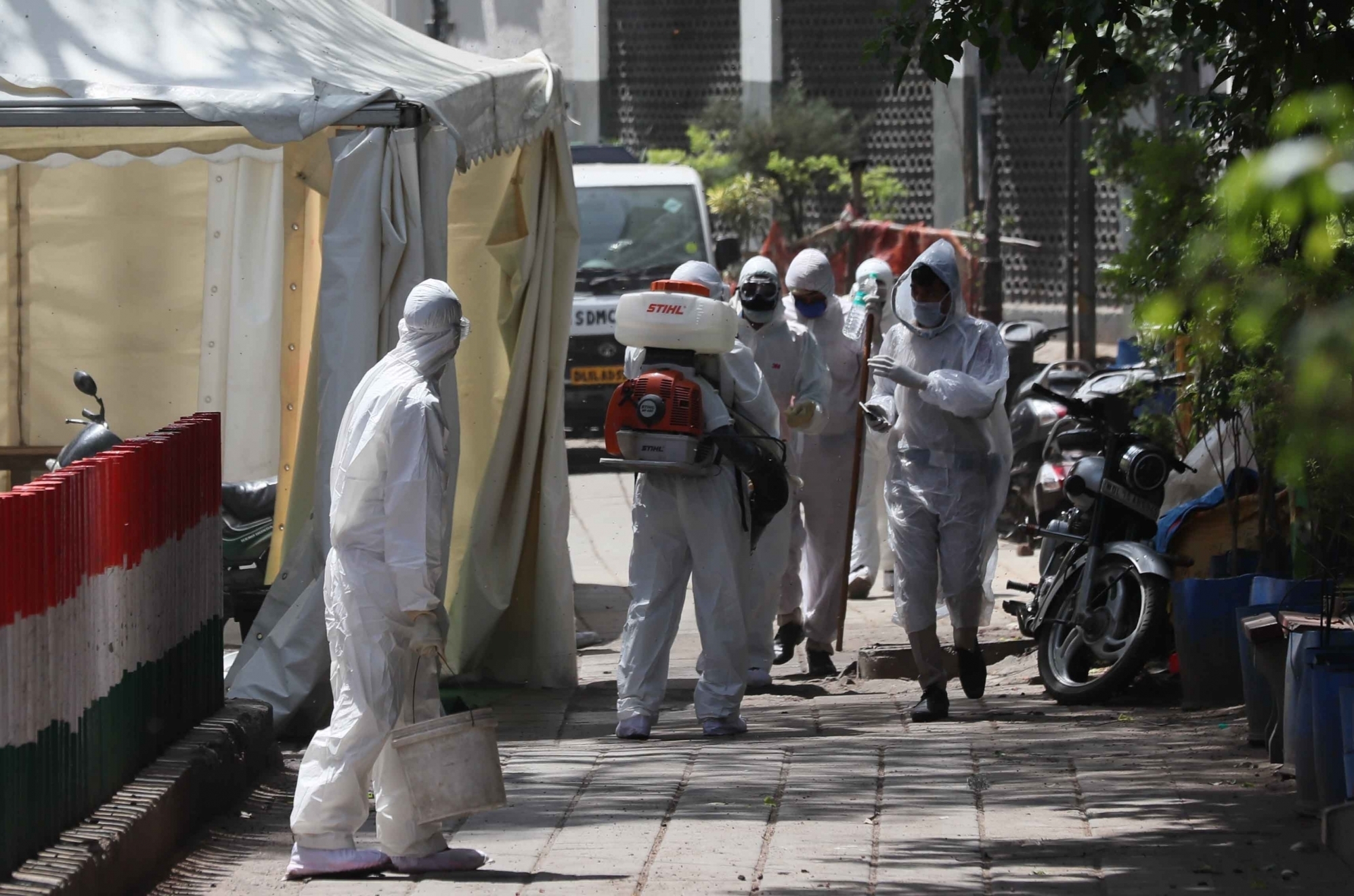New Delhi: Municipal workers wearing protective gear spray disinfectants to sanitise Delhi's Nizamuddin area where 24 cases of positive coronovirus were detected till Tuesday late night, during the 21-day nationwide lockdown (that entered its 8th day) imposed as a precautionary measure to contain the spread of coronavirus, on Apr 1, 2020. (Photo: IANS)