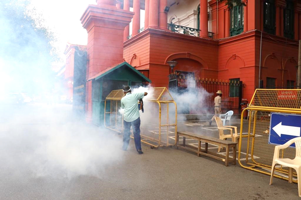 Bengaluru: A municipal worker fumigates the premises of Karnataka High Court amid COVID-19 pandemic, in Bengaluru on June 30, 2020. (Photo: IANS)