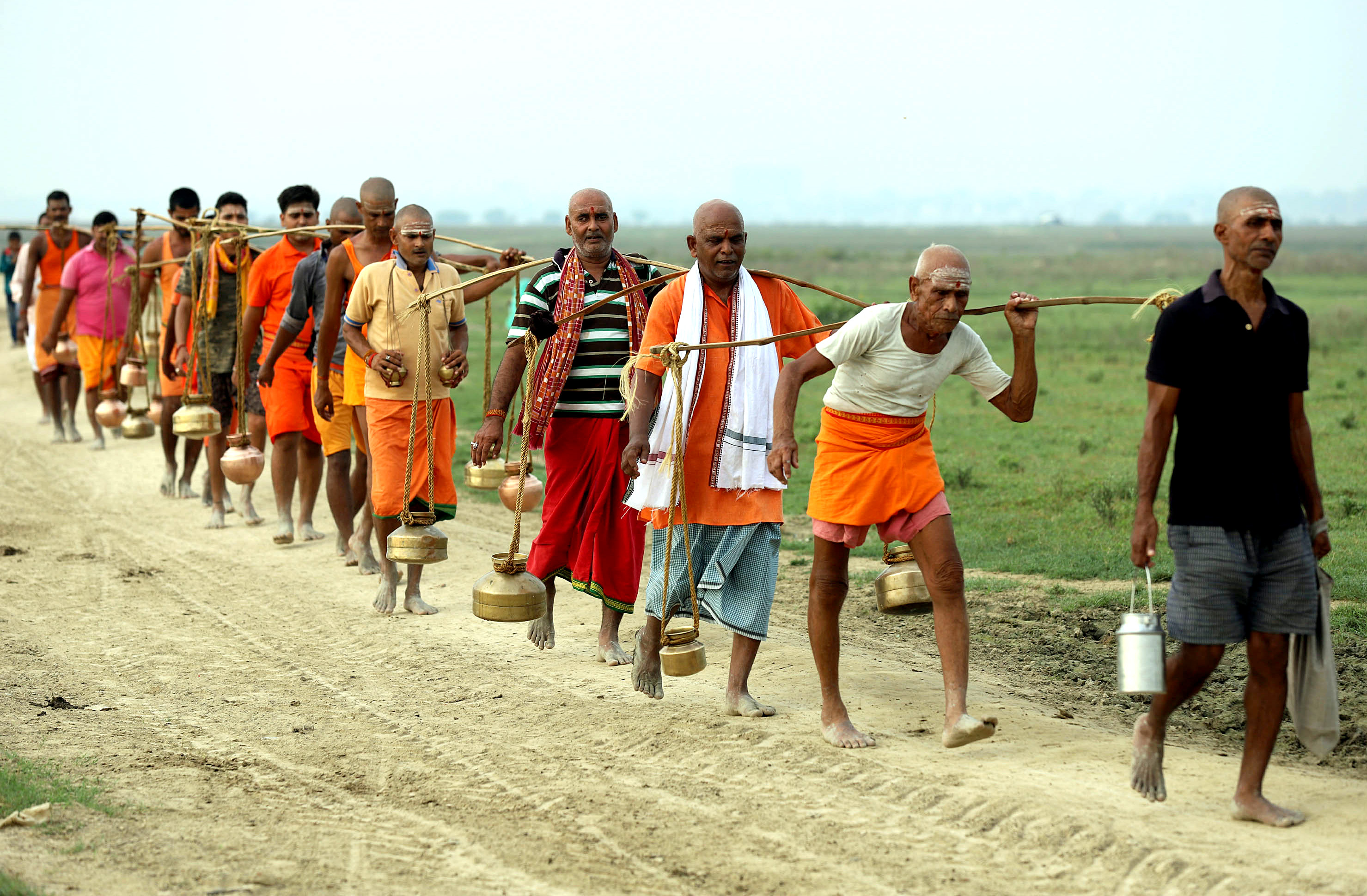 Kanwariyas carry metal pots filled with holy water