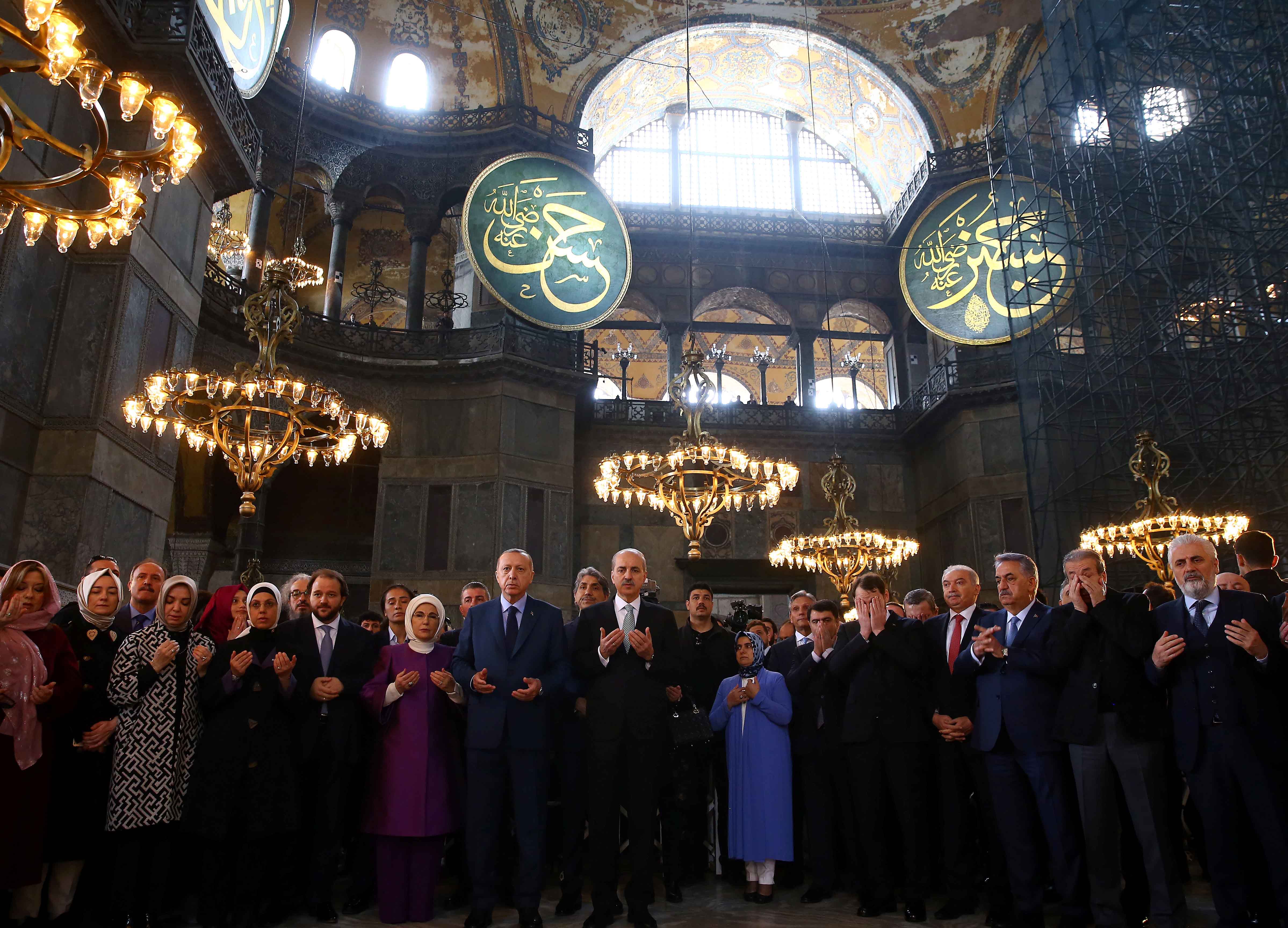 Turkish President Tayyip Erdogan prays during the opening ceremony of the Yeditepe Biennial