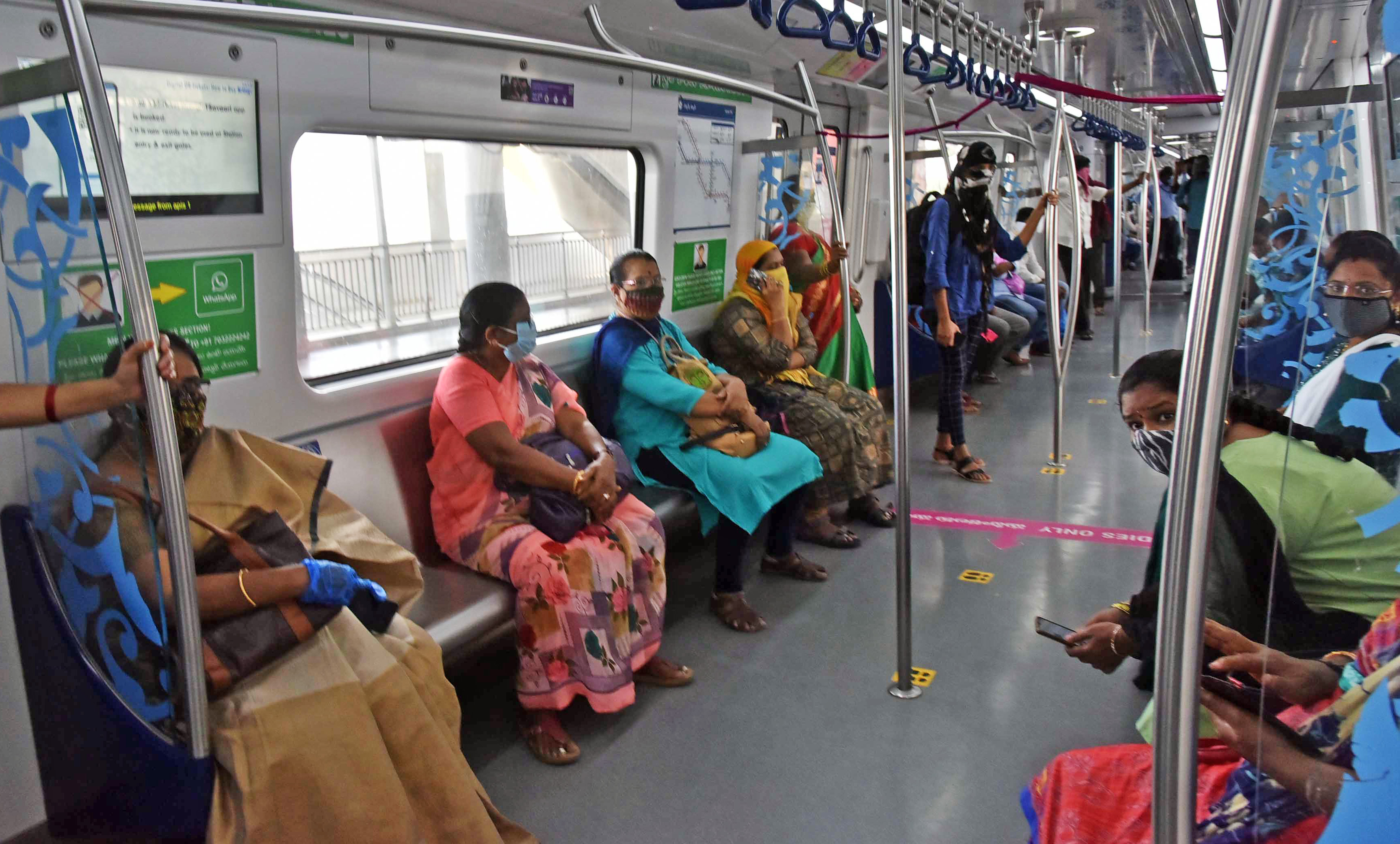 Passengers maintain social distancing in the metro coach