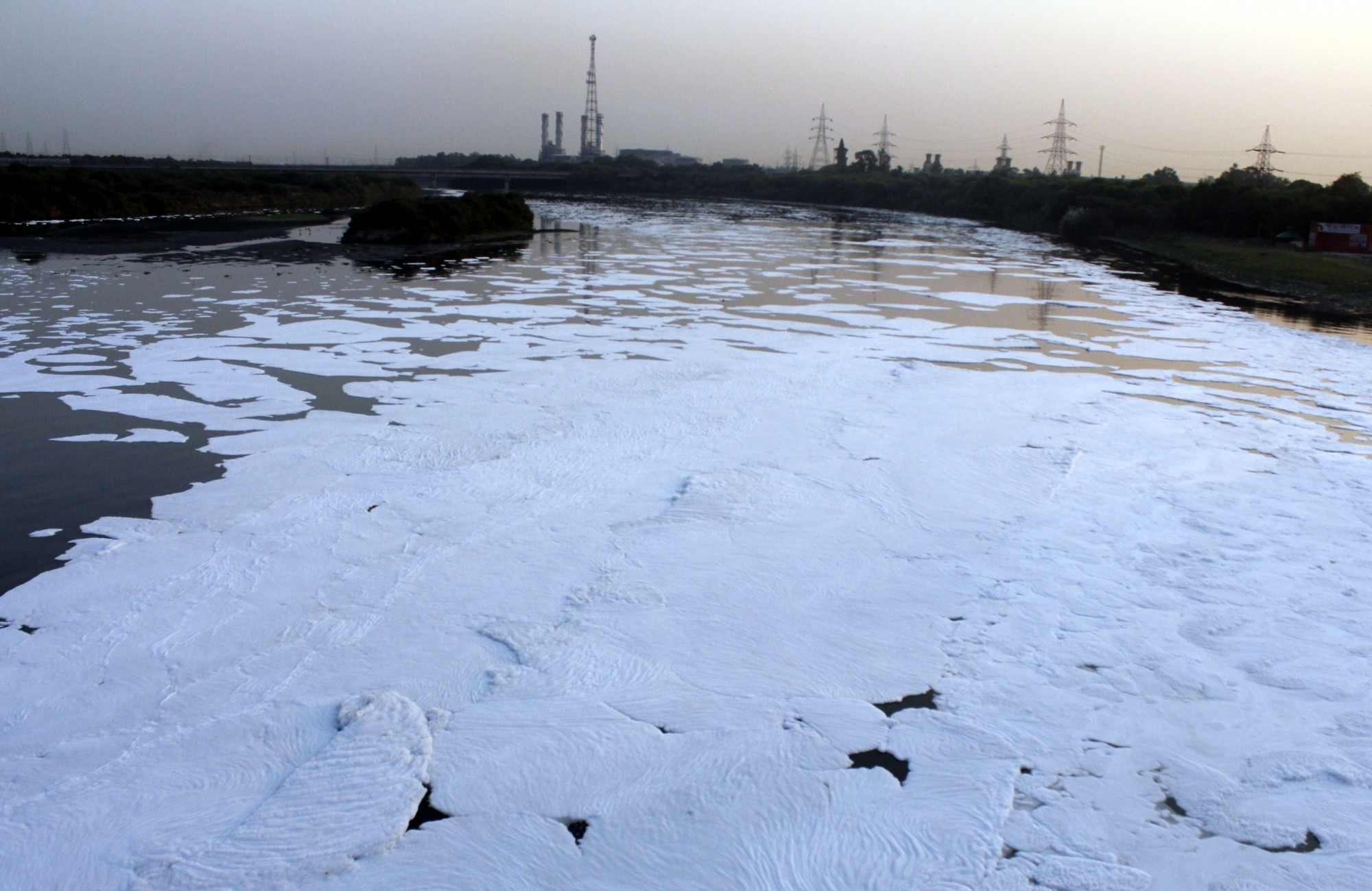 New Delhi: Extreme air pollution and toxic industrial pollutants discharged into the Yamuna river has caused large amounts of white, toxic foam to form on the river, as seen in New Delhi on Oct 21, 2020. (Photo: IANS)