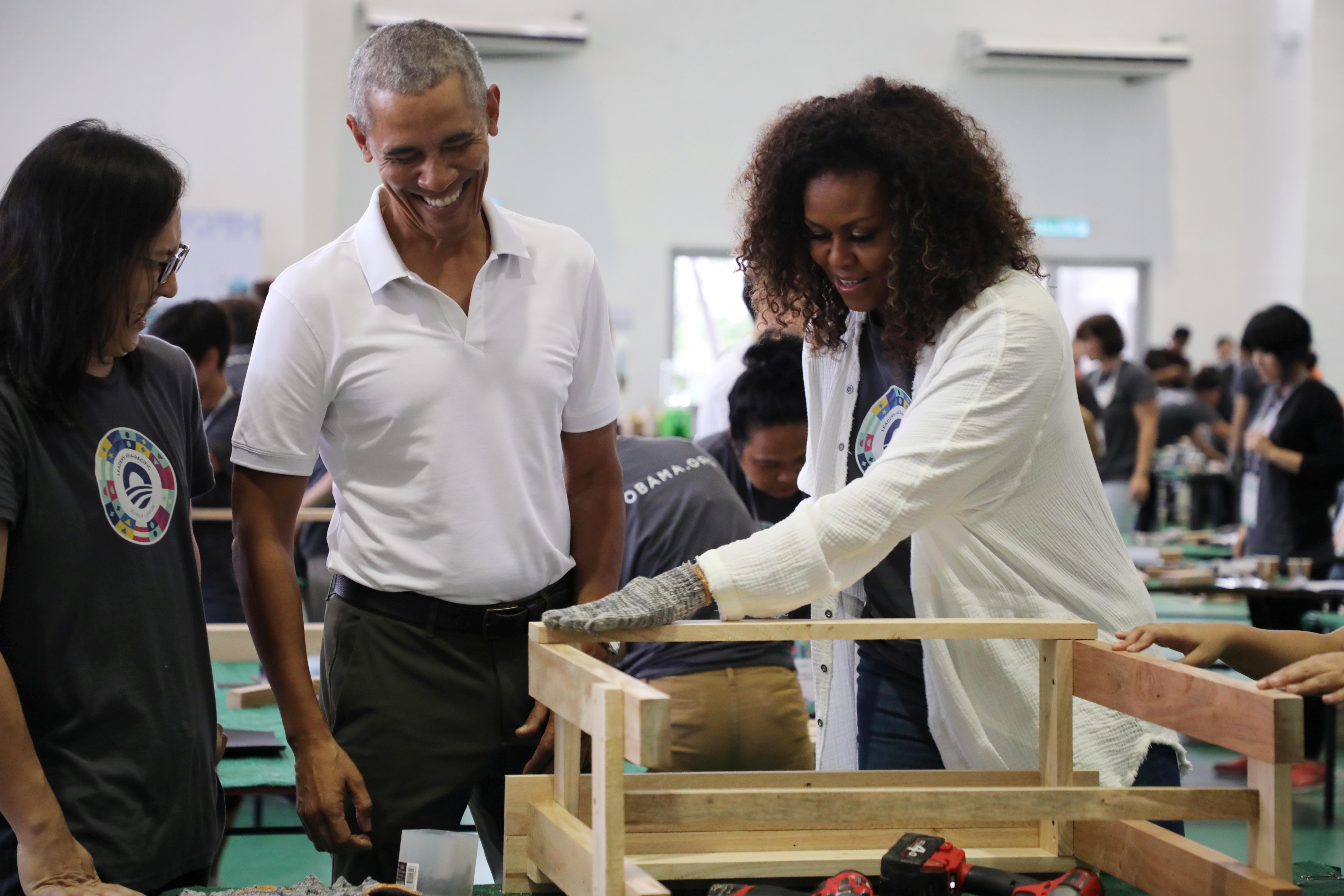 Former U.S. President Barack Obama and former first lady Michelle Obama attend a community service project