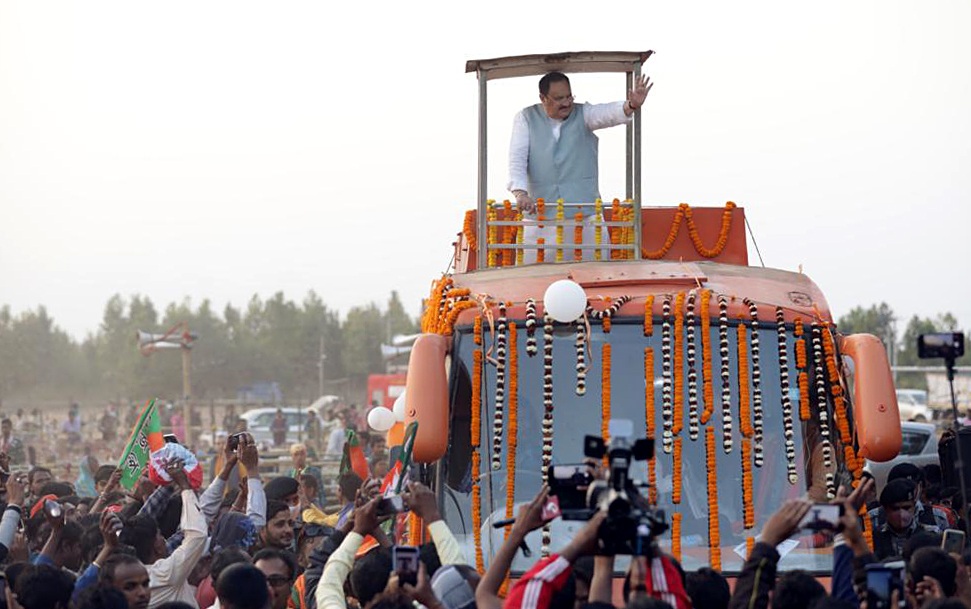 BJP National President J.P. Nadda waves during the launch of