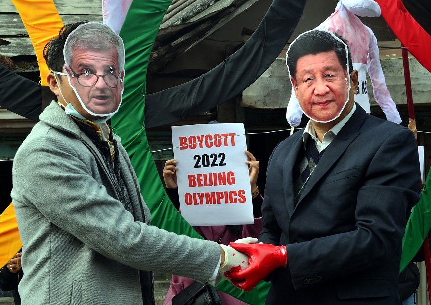 Activists protest wearing masks of IOC president Thomas Bach (L) and Chinese President Xi Jinping
