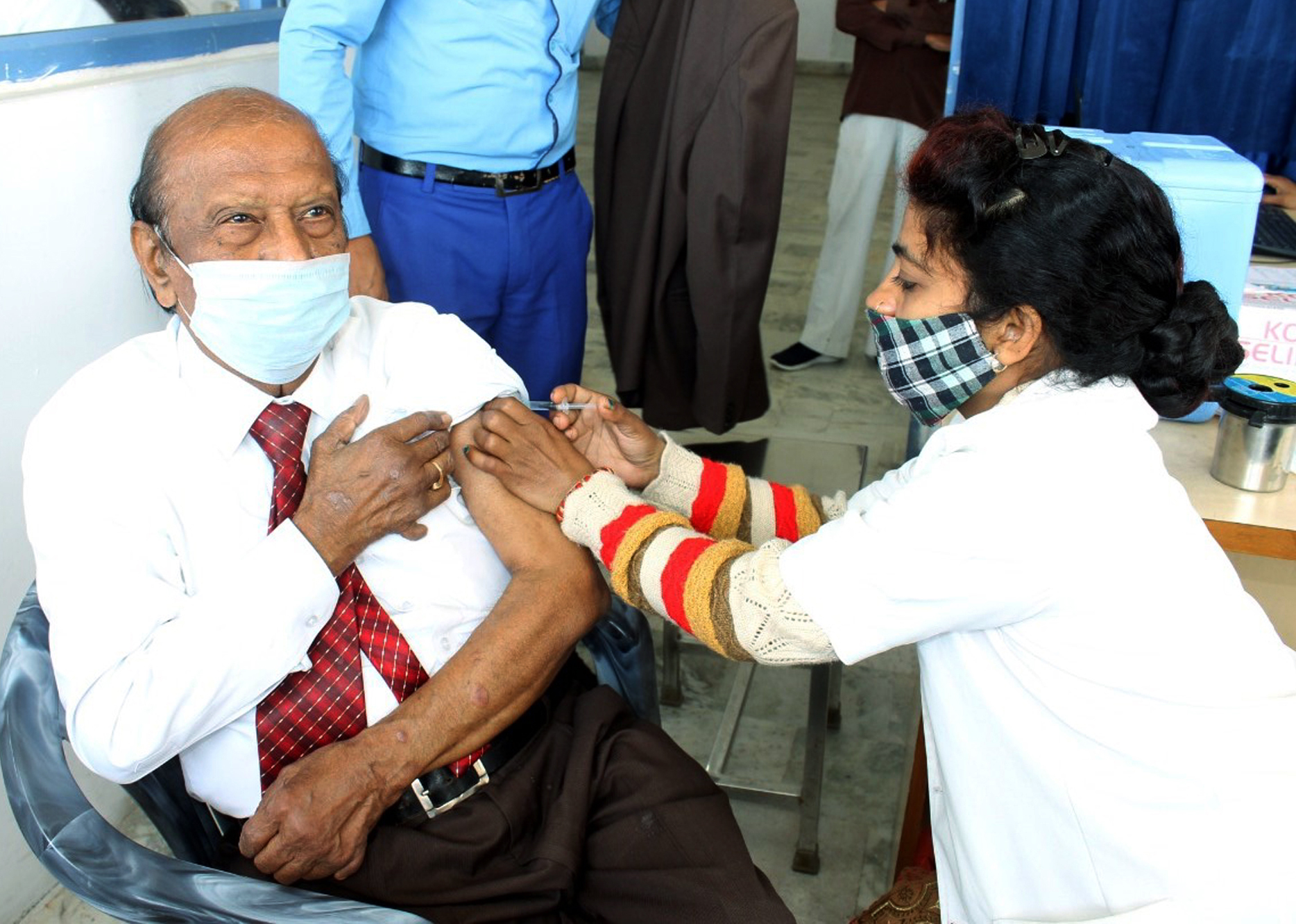 A beneficiary gets the shot of COVID-19 vaccine
