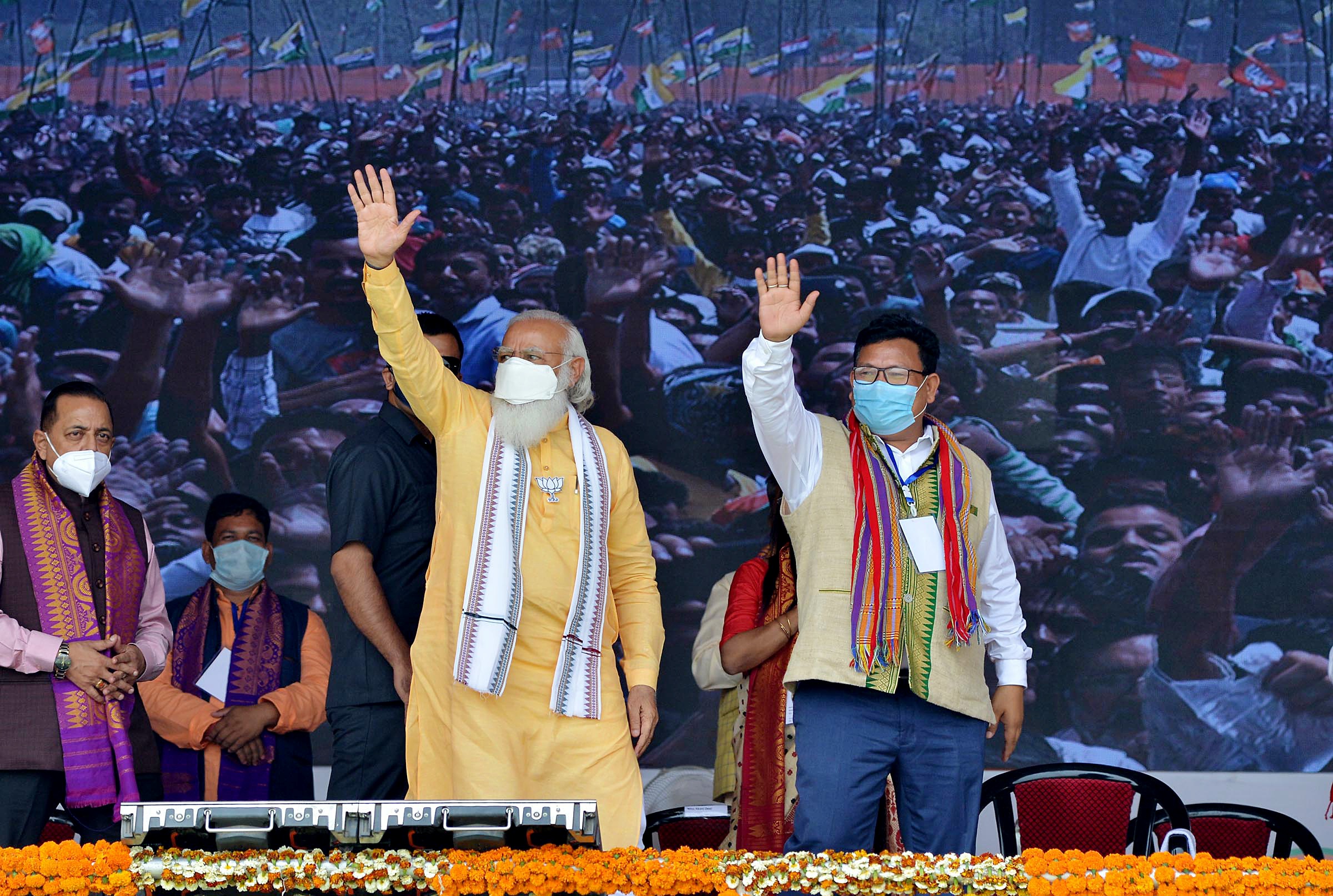 Prime Minister Narendra Modi waves to supporters during an election public rally