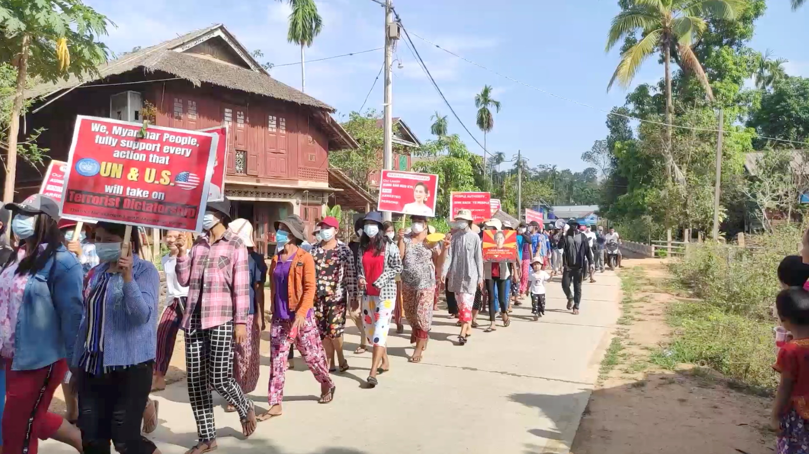 Villagers march during a protest against the military coup, in Launglon