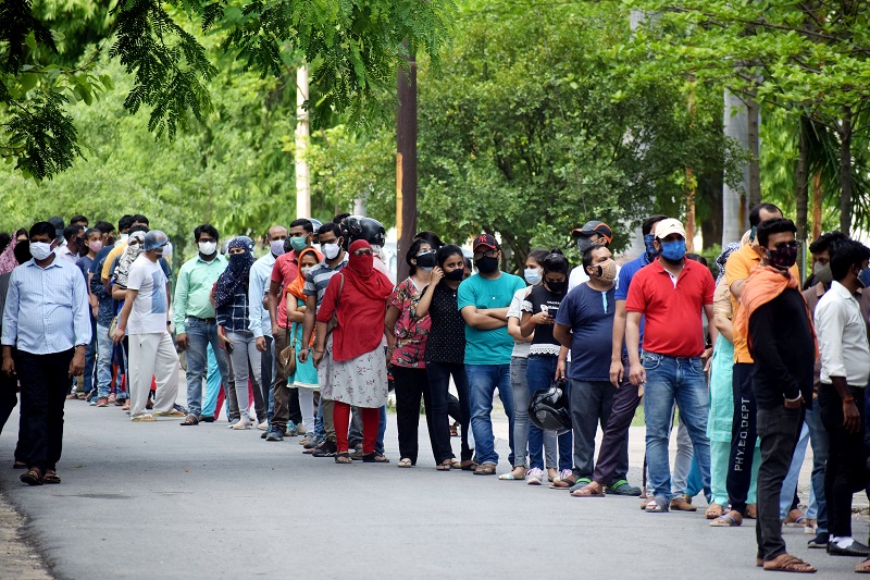 People stand in a queue to receive the dose of the COVID19 vaccine