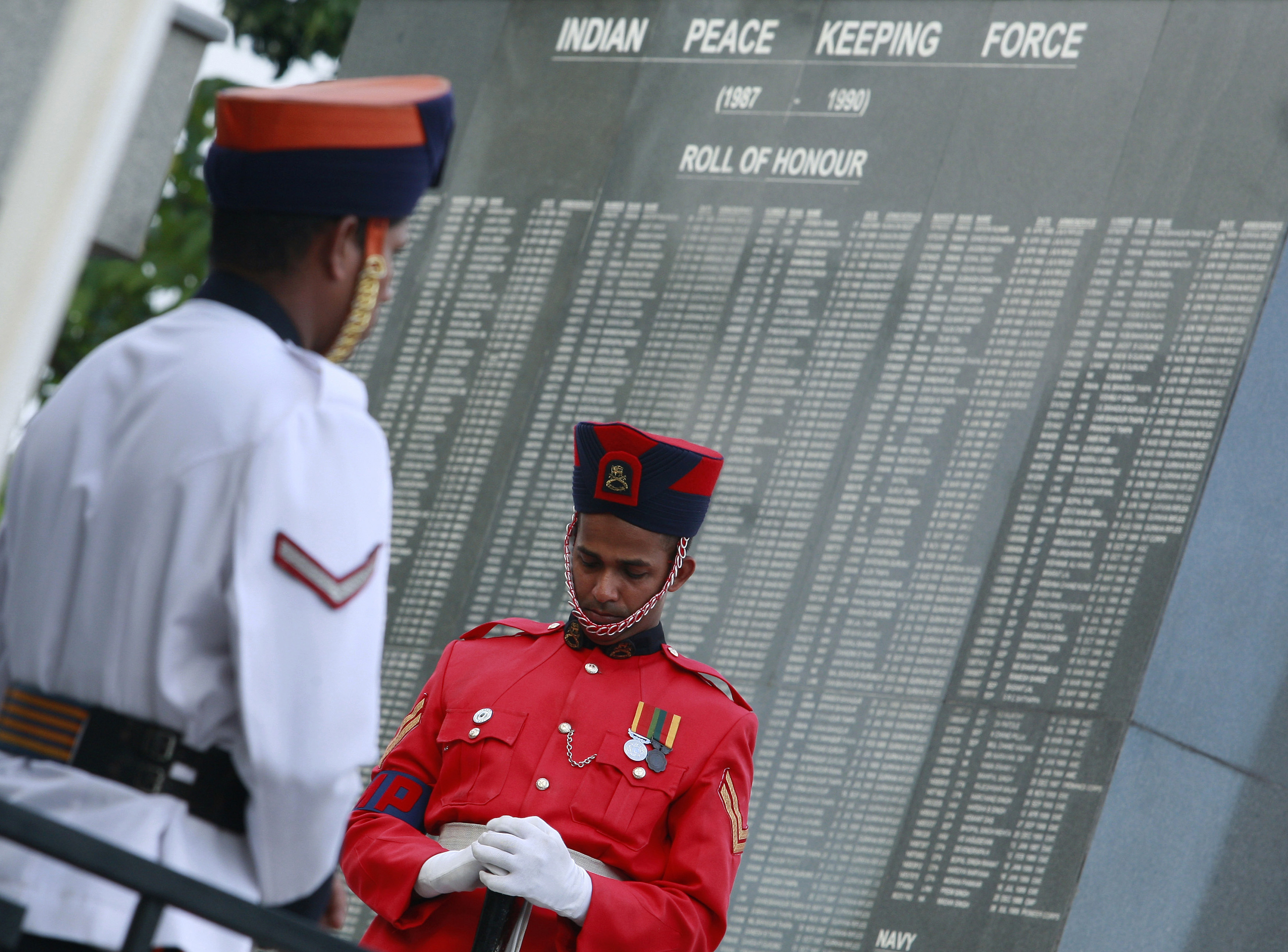 A solider bows his head in front of an Indian Peace keeping force memorial during a commemoration ceremony attended by India's Commander of the army, General Singh, in Colombo.