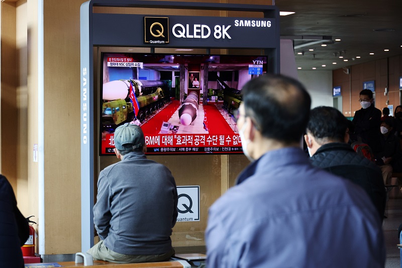 People watch a TV broadcasting file footage of a news report on North Korea firing a ballistic missile off its east coast, in Seoul