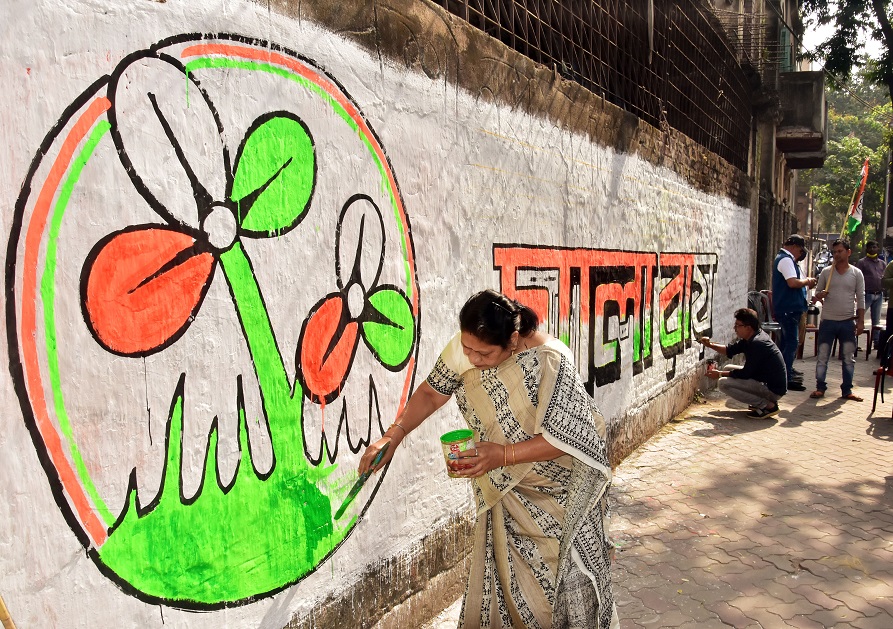 TMC MP Mala Roy paints a graffiti of the party symbol ahead of the Kolkata Municipal Corporation Elections