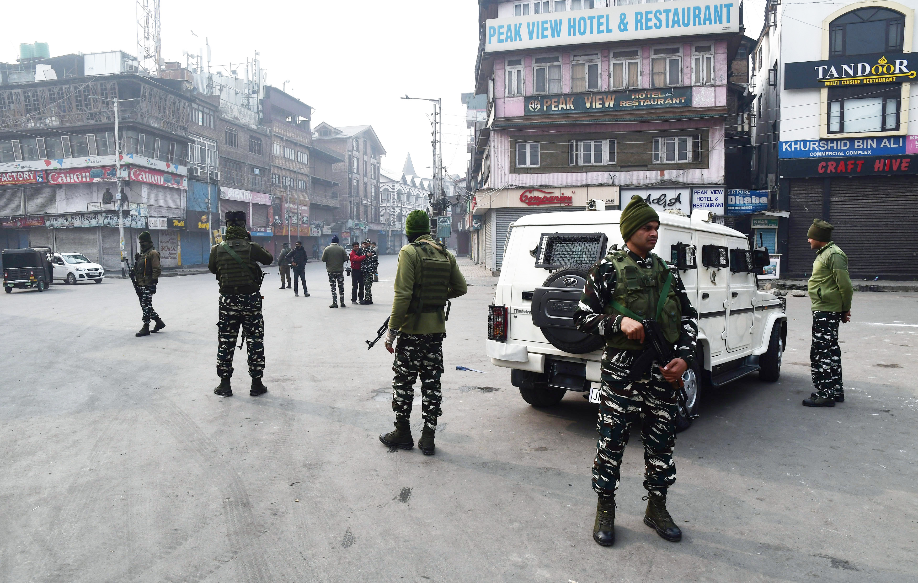 Security personnel stand guard at Lal Chowk during a strike called by separatist leaders against the alleged killing of civilians in the Hyderpora encounter