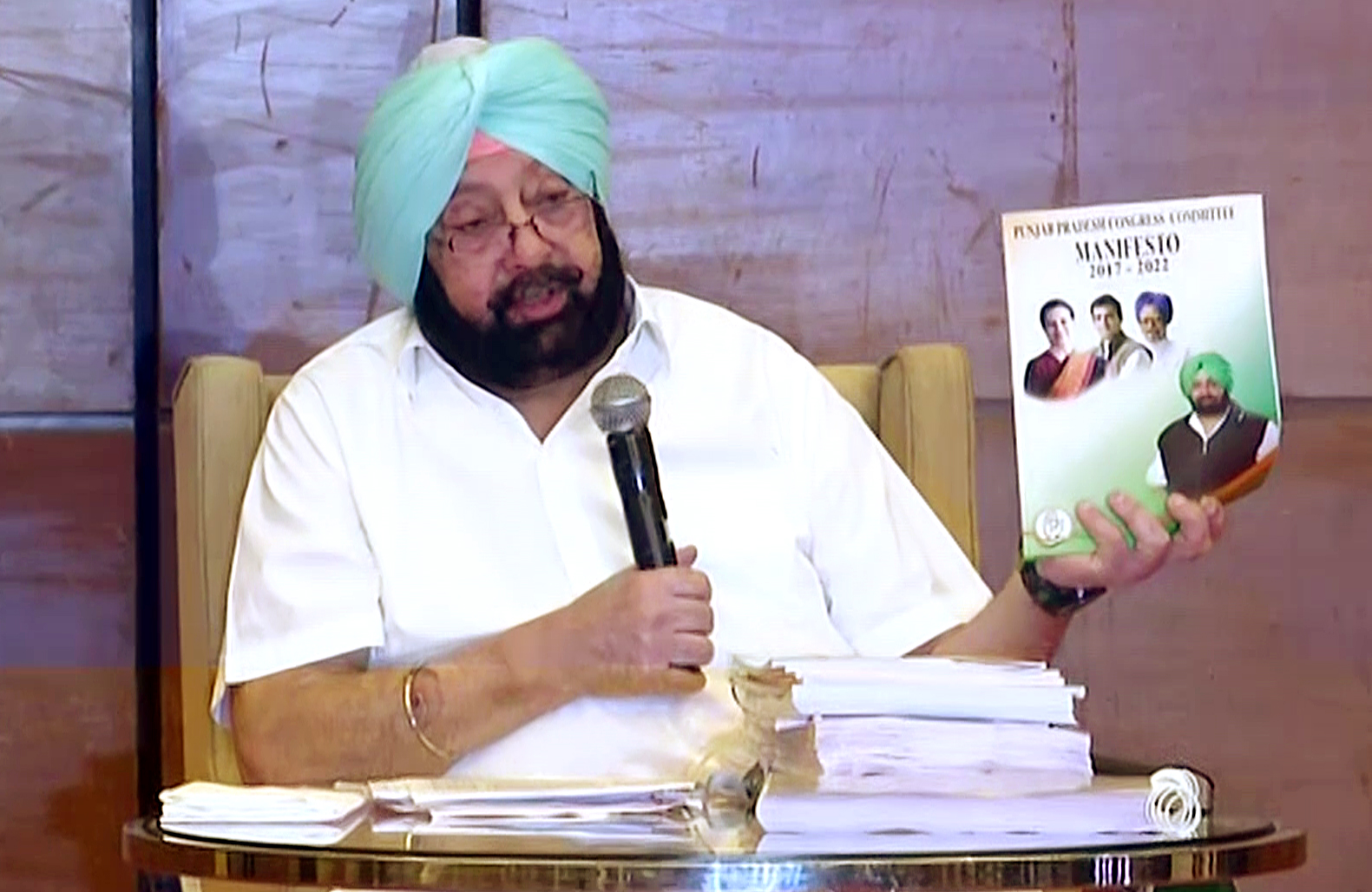 Former Punjab CM Capt Amarinder Singh shows Congress 2017 election manifesto for Punjab Assembly Elections during a press conference