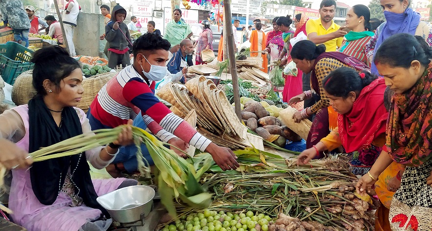 People purchase worshipping material at a market during the Chatth Puja