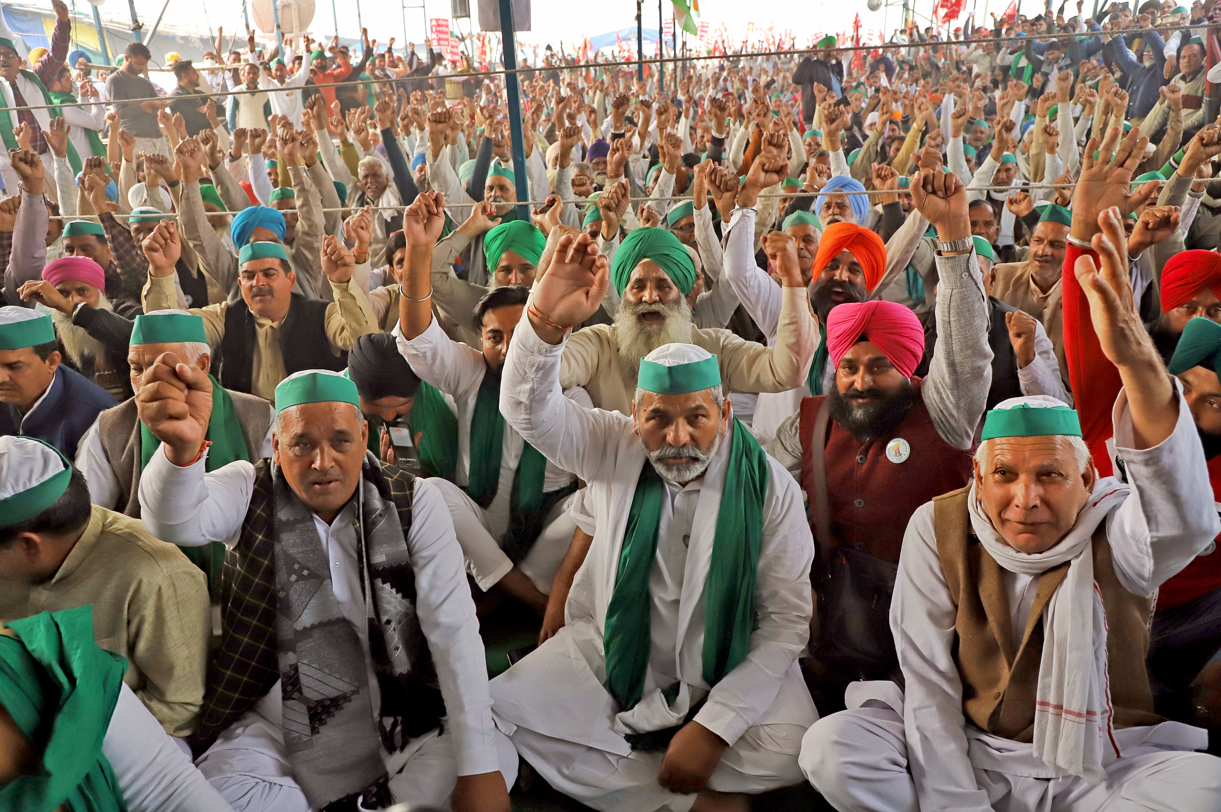 BKU leader Rakesh Tikait(C) with supporters shouting slogans at Ghazipur on the first anniversary of protest