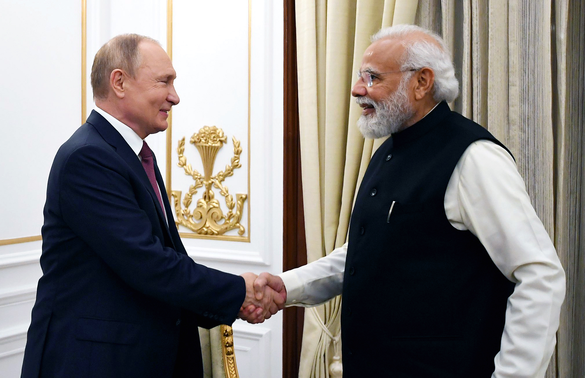 Prime Minister Narendra Modi greets Russian President Vladimir Putin at the 21st annual India-Russia summit