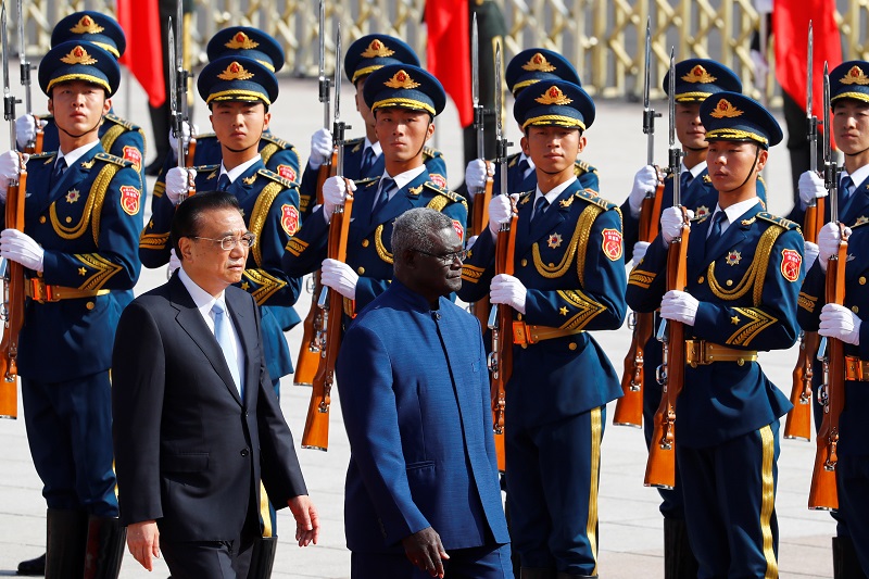 Solomon Islands Prime Minister Manasseh Sogavare reviews the honour guard during a welcome ceremony with Chinese Premier Li Keqiang outside the Great Hall of the People in Beijing