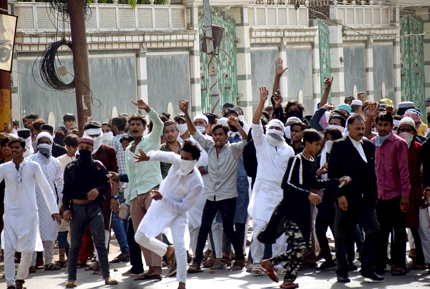 Protestors pelting stone during a protest