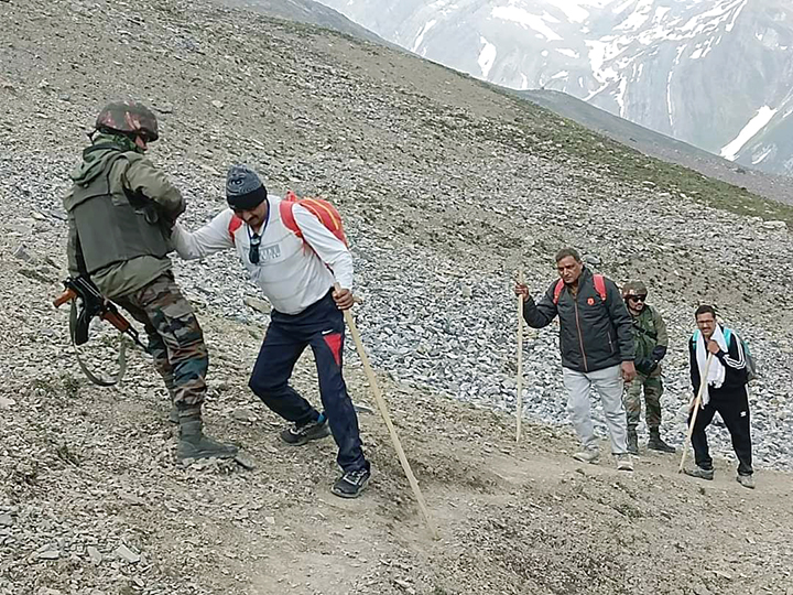 Army personnel assist the pilgrims during their journey to the Amarnath shrine