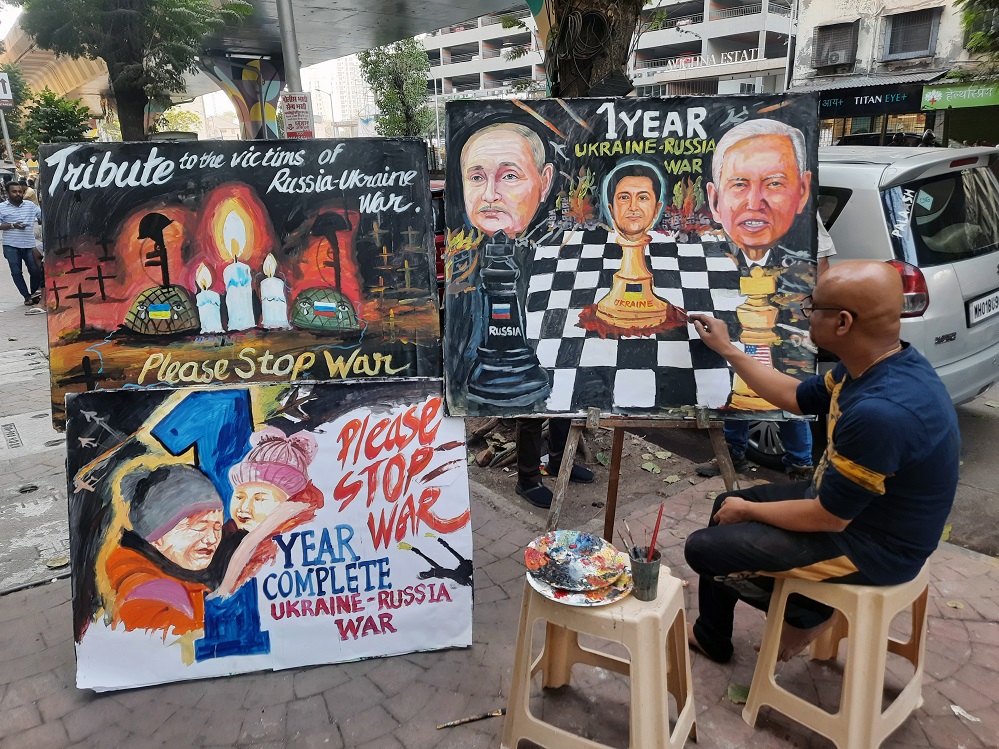 A teacher of Gurukul school makes a painting on 'One year Ukraine - Russia war'