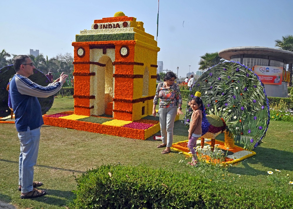 A girl poses for photos at a two-day G20-themed flower festival at Connaught Place