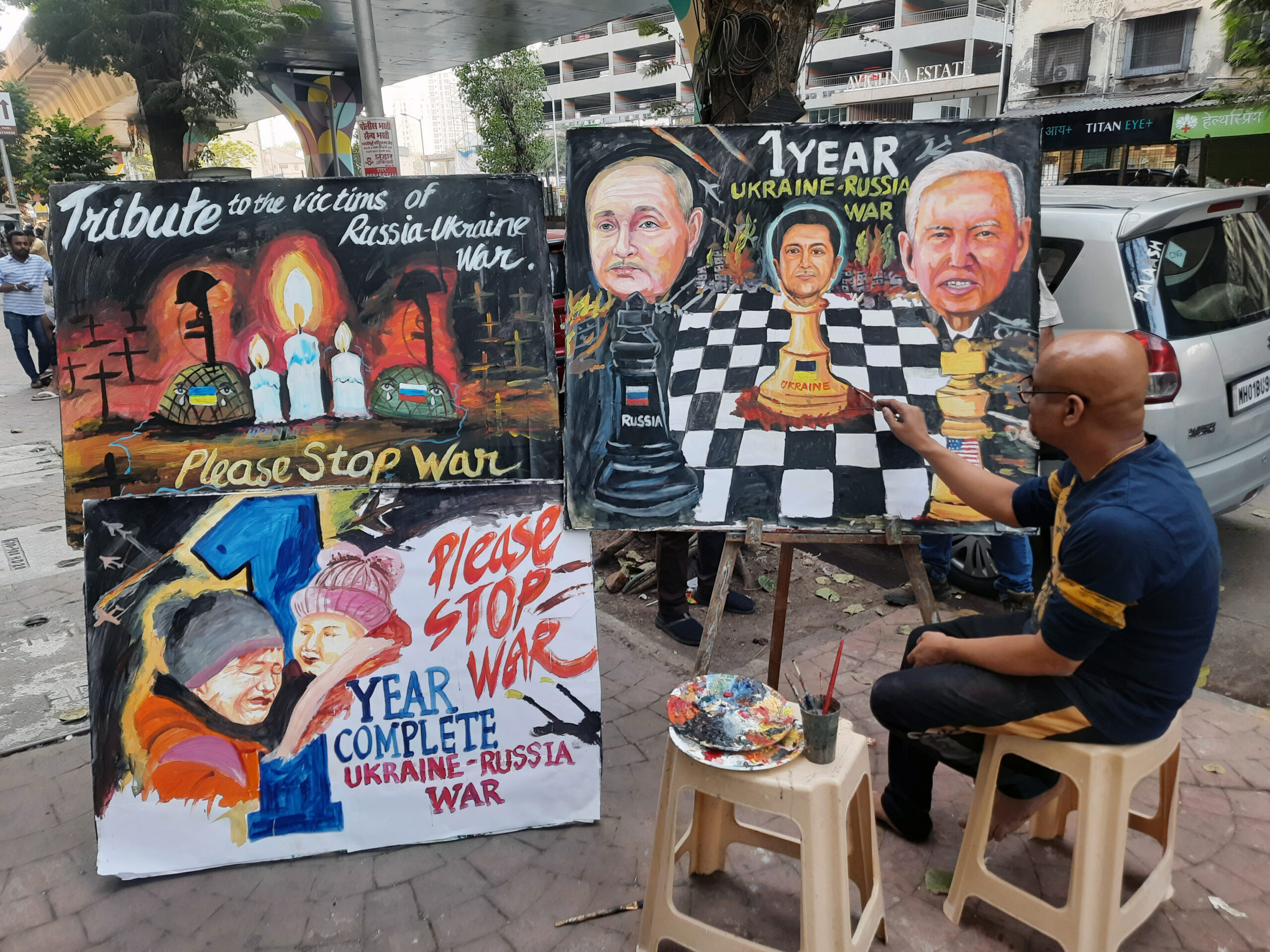 A teacher of Gurukul school makes a painting on 'One year Ukraine - Russia war'