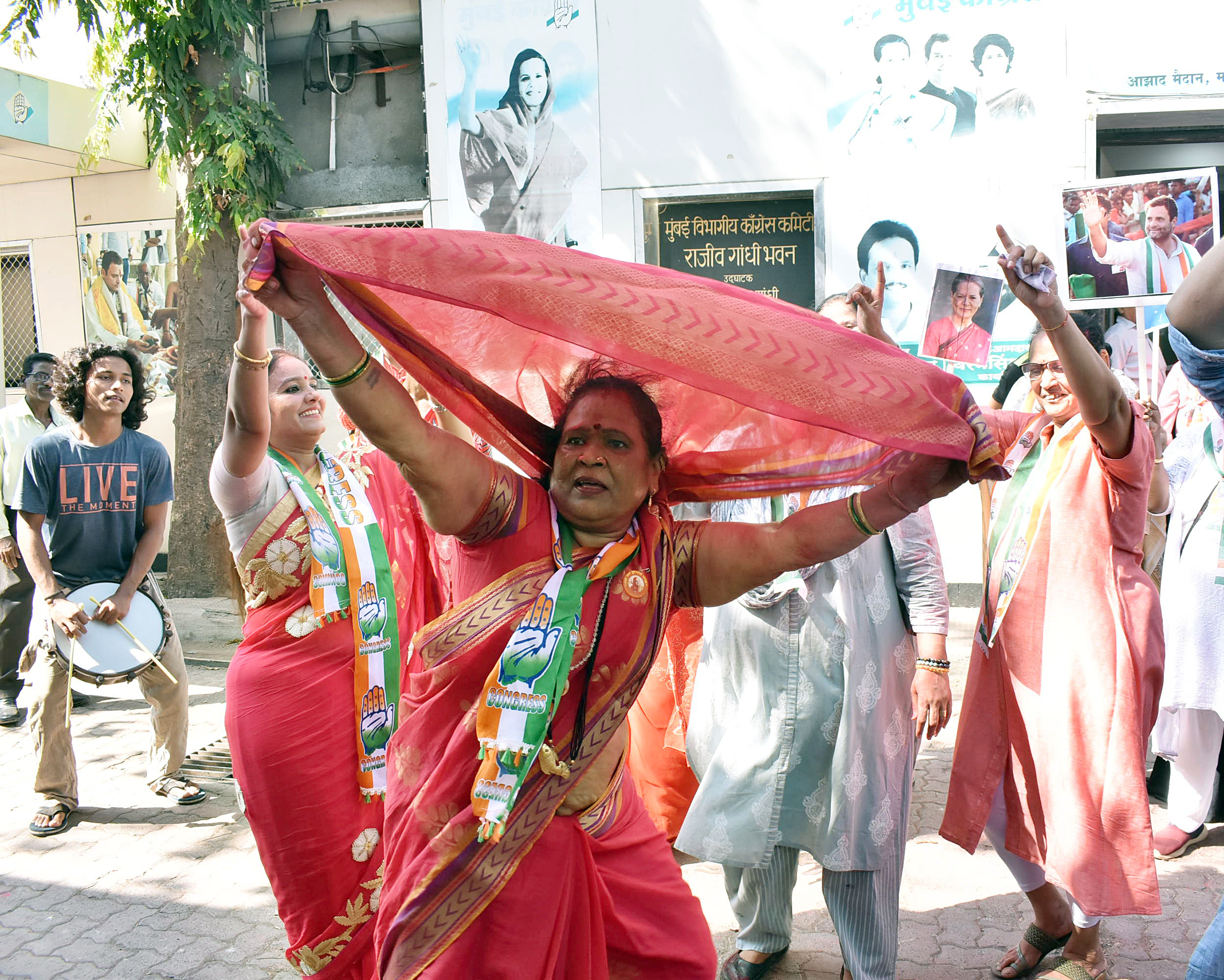 Congress party women workers and supporters dance as they celebrate party's win