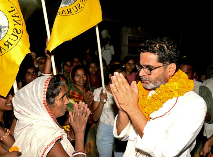 Prashant Kishor greets an elderly woman during the 'Jan Suraj Padayatra'